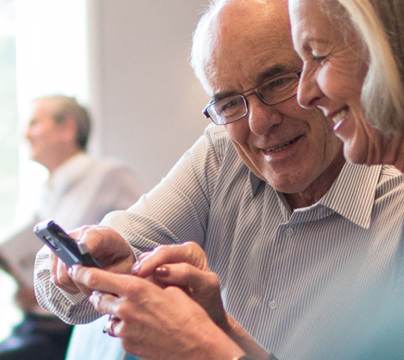 Smiling couple using their smartphone