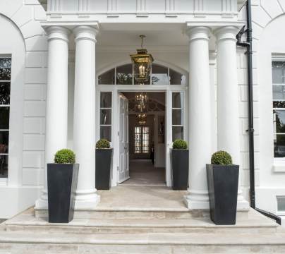 Covered entrance with columns and stone steps