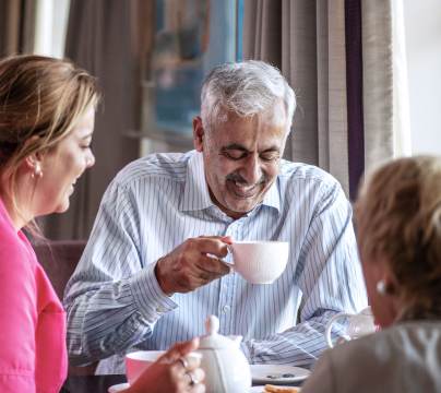 Couple enjoying tea with carer