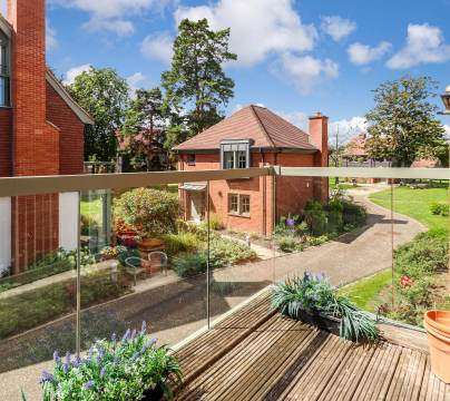 View from the balcony onto a walkway and brick cottages