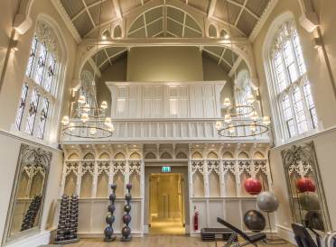 The gym in Grade II* listed Binswood Hall Weight training equipment in Victorian gothic hall