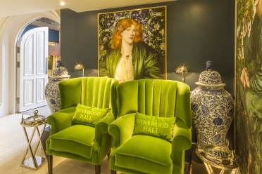 Comfortable green chairs, large pre-Raphaelite paintings and blue/white pots