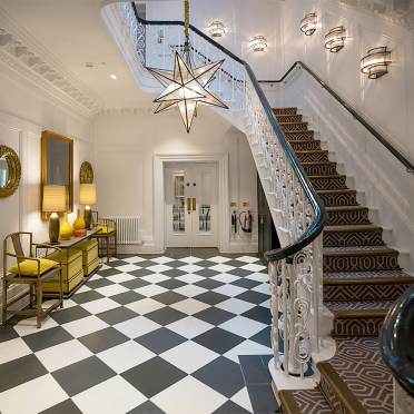 Manor house hall with chess tiles and splendid staircase