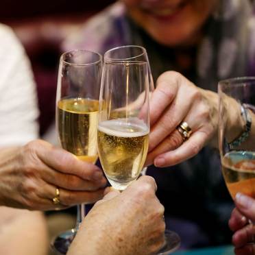 Senior ladies cheering with Champagne. Close up.