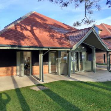 Modern building with red pitched roof