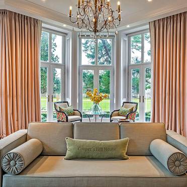 A bright lounge with wide windows and chandelier