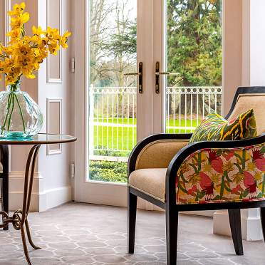 Brightly lit sitting room with soft furnishings