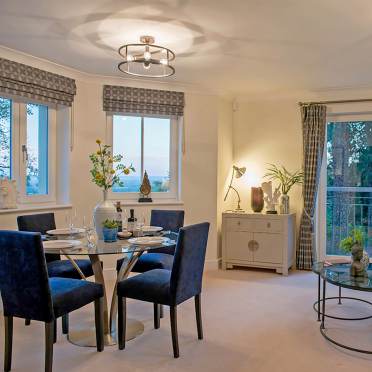 Bright living room with french doors and dining area