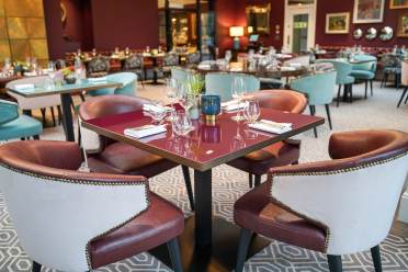 Tables in a luxurious restaurant with red walls