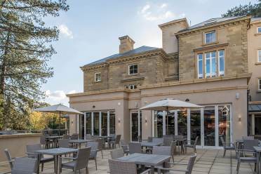 Restaurant terrace and pale-stone mansion