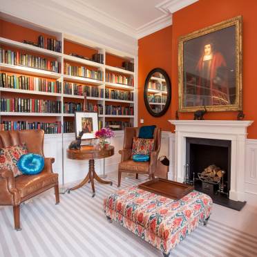 Crimson interior in a luxury lounge with bookshelves