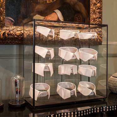 Shirt collars in a glass display case