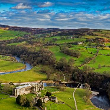 Aerial view on an abbey and green fields