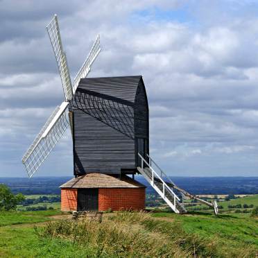 A black old mill in the fields