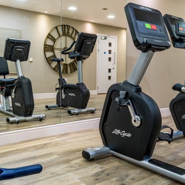 Gym equipment reflected in a wall mirror