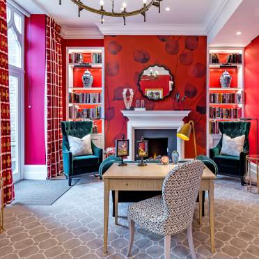 Red walls and curtains with traditional fireplace