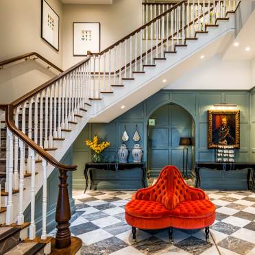 L-shaped staircase above wood-panelled lobby