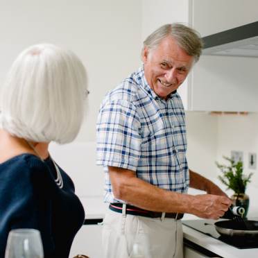 Man smiling whilst cooking