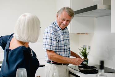 Man smiling whilst cooking