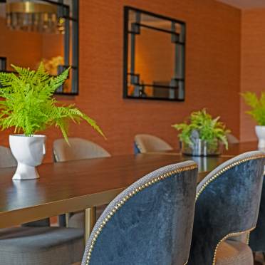 Comfortable restaurant seating with potted ferns