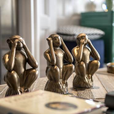 Three wise monkey statuettes