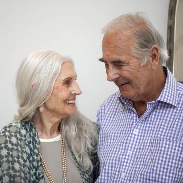 A senior lady smiling to a senior man 