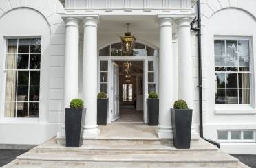 Covered entrance with columns and stone steps