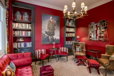 Luxury lounge with bookshelves and chandelier