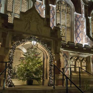 Exterior entrance to Binswood Hall with Christmas decorations at night.