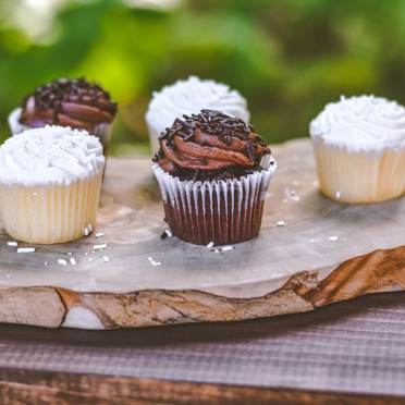 Chocolate and vanilla cakes on  wooden board