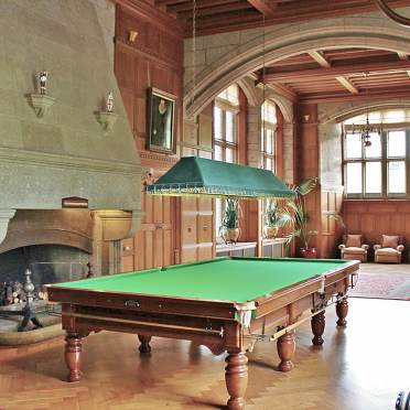 Green baize billiard table in grand panelled hall