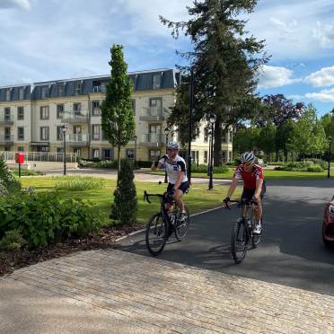 Two riders on bikes in a retirement village