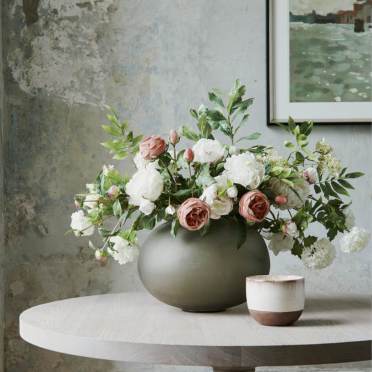 Large peony and rose bouquet in a round vase