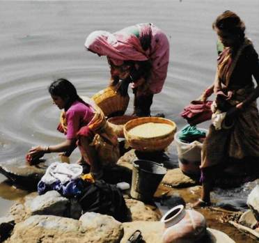 Women washing clothes in river, Kanha, India