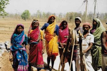 People working outdoors in traditional Indian clothing