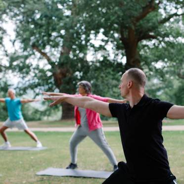 Yoga class in a park with trees