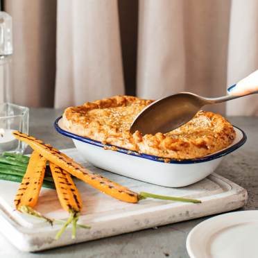 Pie with a spoon ready to break the crust