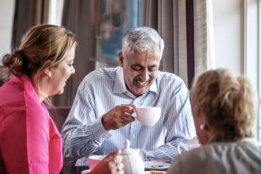 Couple enjoying tea with carer