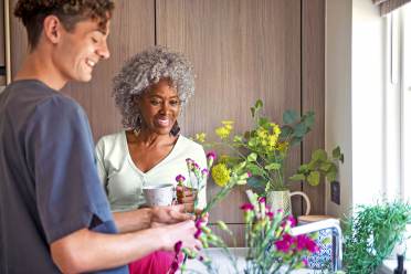 Woman and carer arranging flowers