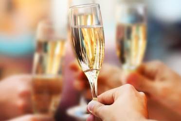 Hand holding a glass of champagne