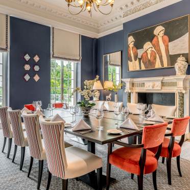 Dining table by a large fireplace