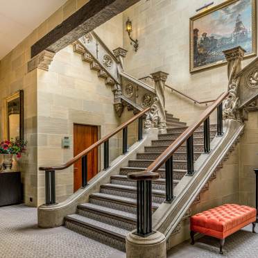 Sweeping stone staircase in mansion
