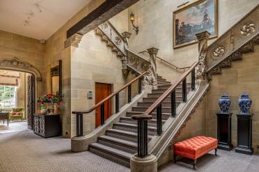 Sweeping stone staircase in mansion house