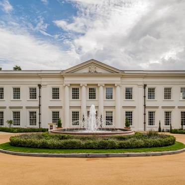 White mansion house with fountain