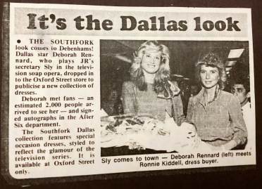 Newspaper clipping featuring two women standing in clothing store, with text about Dallas TV show attire available at a store event, where an actress meets fans and signs autographs.