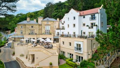 Stone building with apartments and restaurant terrace