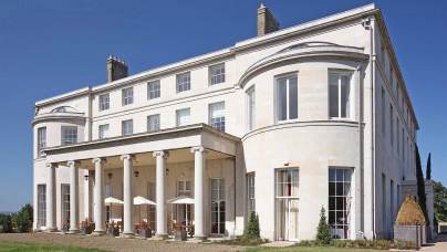 Pale stone mansion against a blue sky
