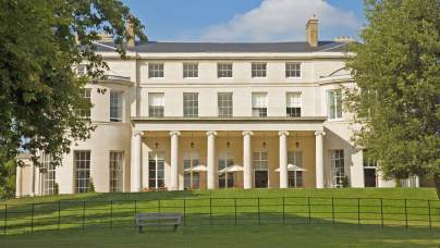 Grand pale-stone mansion with Ionic columns