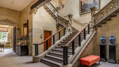 Sweeping stone staircase in mansion house