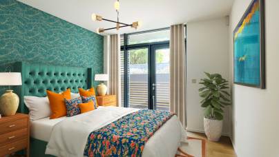 Modern bedroom with a teal accent wall, double bed with colorful linens, two wooden nightstands, a potted plant, abstract art, and a large window with curtains.